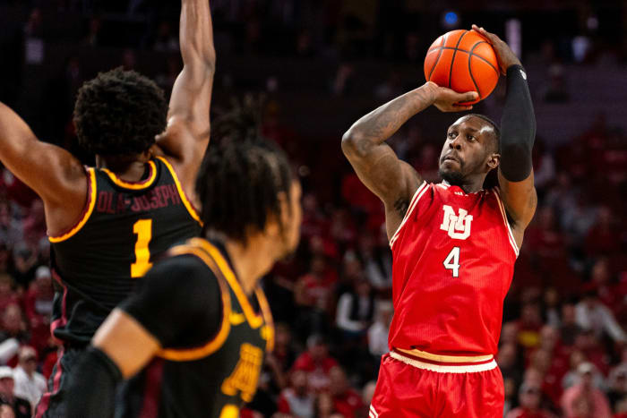 Feb 25, 2024; Lincoln, Nebraska, USA; Nebraska Cornhuskers forward Juwan Gary (4) shoots the ball against Minnesota Golden Gophers forward Joshua Ola-Joseph (1) and guard Elijah Hawkins (0) during the first half at Pinnacle Bank Arena.